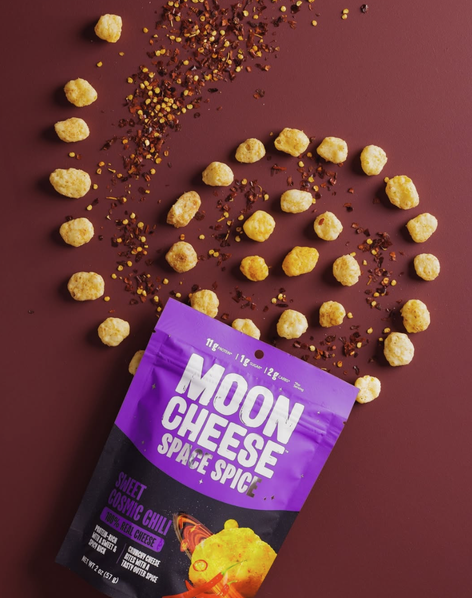 Moon Cheese Space Spice Chipotle Chili flavor in purple packaging with cheese bites scattered around